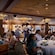 An artist rendering of several Disney Characters greeting Guests in the Navigator’s Club restaurant on the Disney Adventure